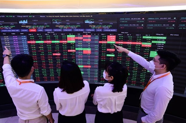 Investors viewing market prices on a stock exchange trading screen